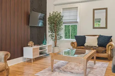 a living room with a couch and a table at Niagara on the Lake Walkable Old Town Retreat in Niagara on the Lake
