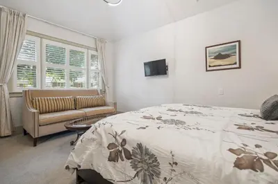 a bedroom with a bed and a couch at Niagara on the Lake Walkable Old Town Retreat in Niagara on the Lake