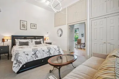 a bedroom with a bed and a table and a couch at Niagara on the Lake Walkable Old Town Retreat in Niagara on the Lake