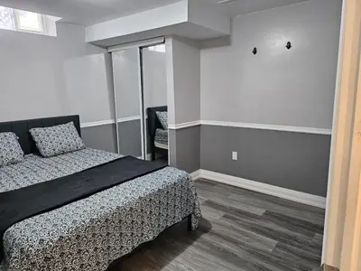 a bedroom with a bed and a mirror in it at 1 BR Bsmt, Sep Entrn, Fre Prkn, Wi-Fi, Ktchn, Lndry in Mississauga