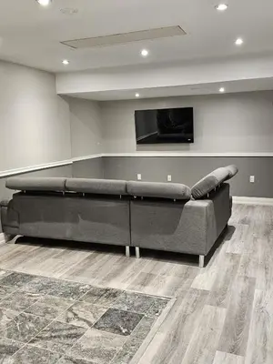 a black couch in a room with a flat screen tv at 1 BR Bsmt, Sep Entrn, Fre Prkn, Wi-Fi, Ktchn, Lndry in Mississauga