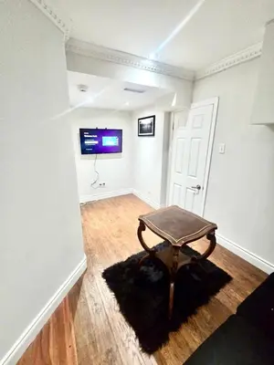 a room with a table in the middle of a room at Quincy Home in Mississauga