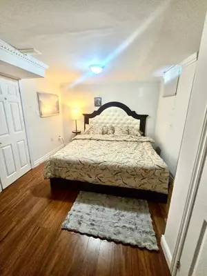 a bedroom with a large bed in a room at Quincy Home in Mississauga