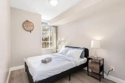 a bedroom with a bed and a window at SkyView 2BR Plus Den Stunning Views Steps to SQ1 Mall in Mississauga