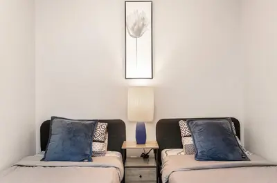 a living room with two beds and a lamp at SkyView 2BR Plus Den Stunning Views Steps to SQ1 Mall in Mississauga