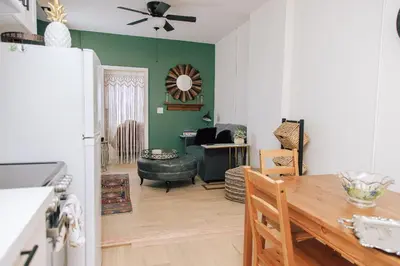 a kitchen and living room with a table and a refrigerator at Dundas and Brock Suitel in Toronto