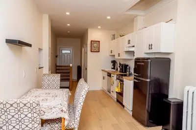 a kitchen with a refrigerator and a table and chairs at Dundas and Brock Suitel in Toronto