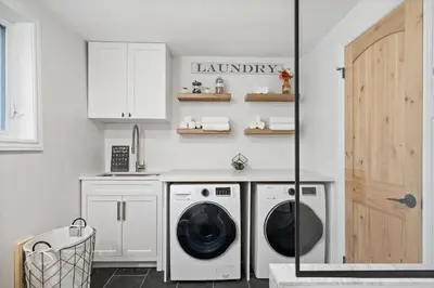 a laundry room with a washer and dryer at Waterfront Casa in wine County with SAUNA and HOT TUB in Demorestville