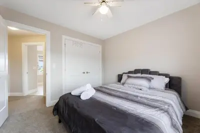 a bedroom with a bed and a ceiling fan at Relaxing Retreat Office, Patio, Nature and Netflix in Colborne