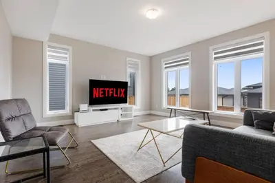 a living room with a tv and a couch at Relaxing Retreat Office, Patio, Nature and Netflix in Colborne