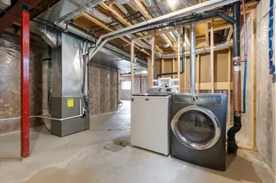 a laundry room with a washing machine in it at Relaxing Retreat Office, Patio, Nature and Netflix in Colborne