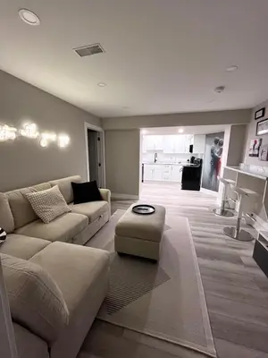 a living room with a couch and a table at Modern Suite in Etobicoke - Near Airport & Downtown! in Toronto