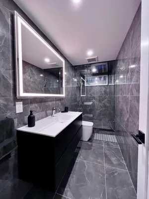 a bathroom with a white sink and a shower at Modern Suite in Etobicoke - Near Airport & Downtown! in Toronto