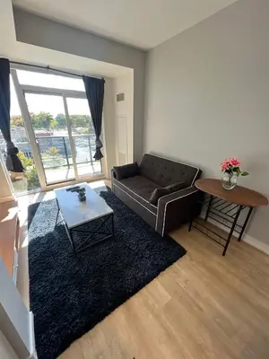 a living room with a couch and a table at Vibrant 1 Bedroom Condo Apt in Toronto