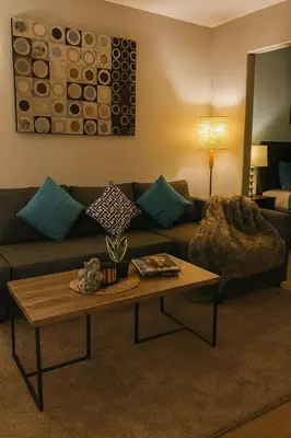 a living room with a couch and a coffee table at King Bed Suite with Pool and Hot Tub Access in Shanty Bay