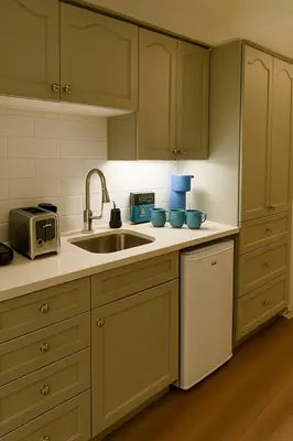 a kitchen with a sink and a microwave at King Bed Suite with Pool and Hot Tub Access in Shanty Bay