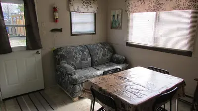 a living room with a couch and a table at The Maples Cottages in Port Elgin in Port Elgin