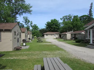 a group of houses and a park with a bench at The Maples Cottages in Port Elgin in Port Elgin