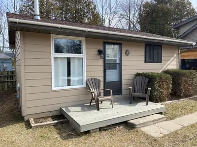 two chairs sitting on a porch of a house at The Maples Cottages in Port Elgin in Port Elgin