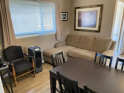 a living room with a couch and a table and chairs at The Maples Cottages in Port Elgin in Port Elgin