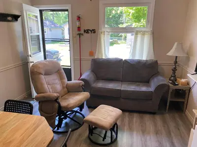 a living room with a couch and a chair at The Maples Cottages in Port Elgin in Port Elgin