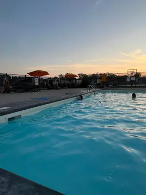 a swimming pool with blue water in a resort at Cottage on Niagara on the Lake in Niagara on the Lake