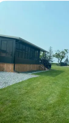 a building with a grassy field in front of it at Cottage on Niagara on the Lake in Niagara on the Lake