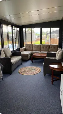 a large living room with couches and a rug at Cottage on Niagara on the Lake in Niagara on the Lake