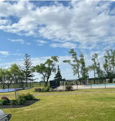 a park with a fence and a grass field at Cottage on Niagara on the Lake in Niagara on the Lake