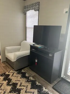 a living room with a flat screen tv and a couch at Cottage on Niagara on the Lake in Niagara on the Lake