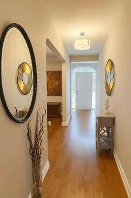 a hallway with a large mirror and a table at Spacious 5-Bedroom House in Thornhill in Vaughan