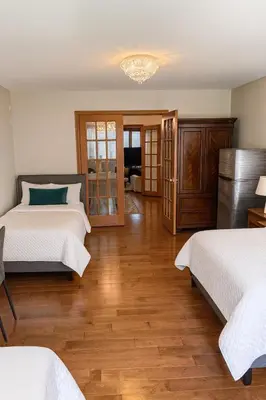 a bedroom with two beds and a wooden floor at Spacious 5-Bedroom House in Thornhill in Vaughan