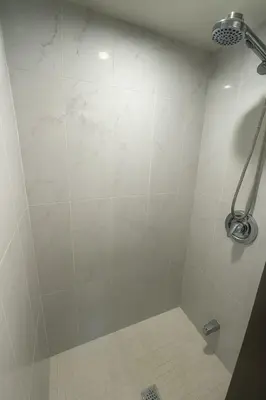 a shower in a bathroom with a white tile floor at Spacious 5-Bedroom House in Thornhill in Vaughan
