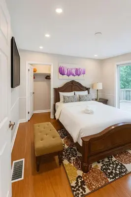 a bedroom with a large bed and a tv at Spacious 5-Bedroom House in Thornhill in Vaughan