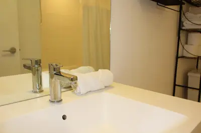 a bathroom sink with a white towel on it at The Nest in Toronto