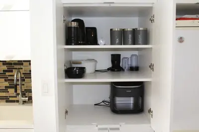 a kitchen pantry with a coffee maker on a shelf at The Nest in Toronto