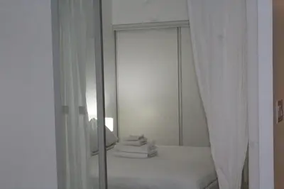 a mirror with a pile of towels in a bathroom at The Nest in Toronto