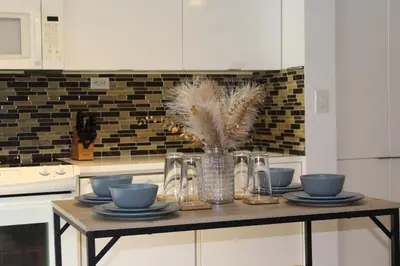 a kitchen with a table with dishes and a vase with feathers at The Nest in Toronto