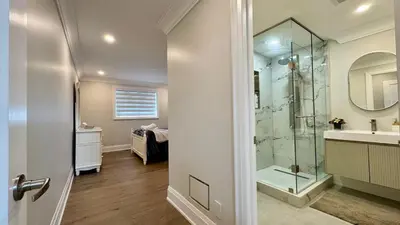 a bathroom with a glass shower and a sink at Luxury 4BR Retreat with Pool, Piano, Spa & Games in Mississauga
