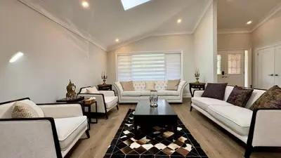 a living room with white couches and a table at Luxury 4BR Retreat with Pool, Piano, Spa & Games in Mississauga