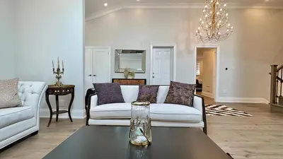 a living room with a couch and a table at Luxury 4BR Retreat with Pool, Piano, Spa & Games in Mississauga