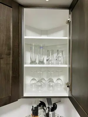 a kitchen cabinet filled with glass wine glasses at Entire Home in Niagara Region, 6 bedrooms, 5 baths with a game room, arcades in Thorold