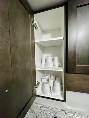 a cupboard with mugs in it in a bathroom at Entire Home in Niagara Region, 6 bedrooms, 5 baths with a game room, arcades in Thorold