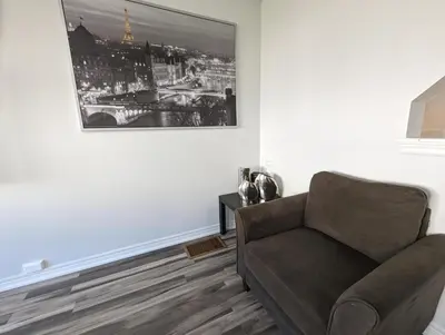 a living room with a couch and a picture on the wall at Entire Home in Niagara Region, 6 bedrooms, 5 baths with a game room, arcades in Thorold