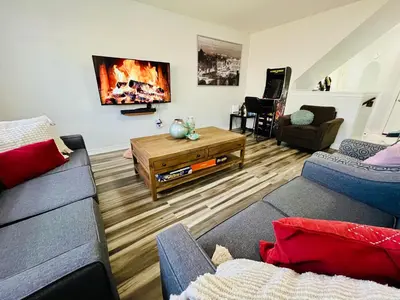 a living room with a couch and a table at Entire Home in Niagara Region, 6 bedrooms, 5 baths with a game room, arcades in Thorold