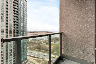 a balcony with a view of a building at Stylish Fort York Condo w Patio Prime Location in Toronto