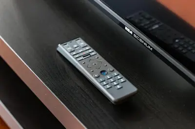 a remote control sitting on top of a table at Chic Fort York Studio Cozy Retreat in Downtown in Toronto