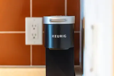 a keurig espresso machine sitting next to a wall at Chic Fort York Studio Cozy Retreat in Downtown in Toronto