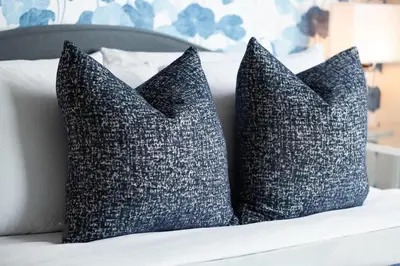 two pillows sitting on top of a bed at Chic Fort York Studio Cozy Retreat in Downtown in Toronto