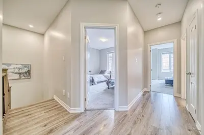 an empty living room with a hallway with a mirror at Spacious 3BR Townhome Near Casino & Thermea Spa in Ajax